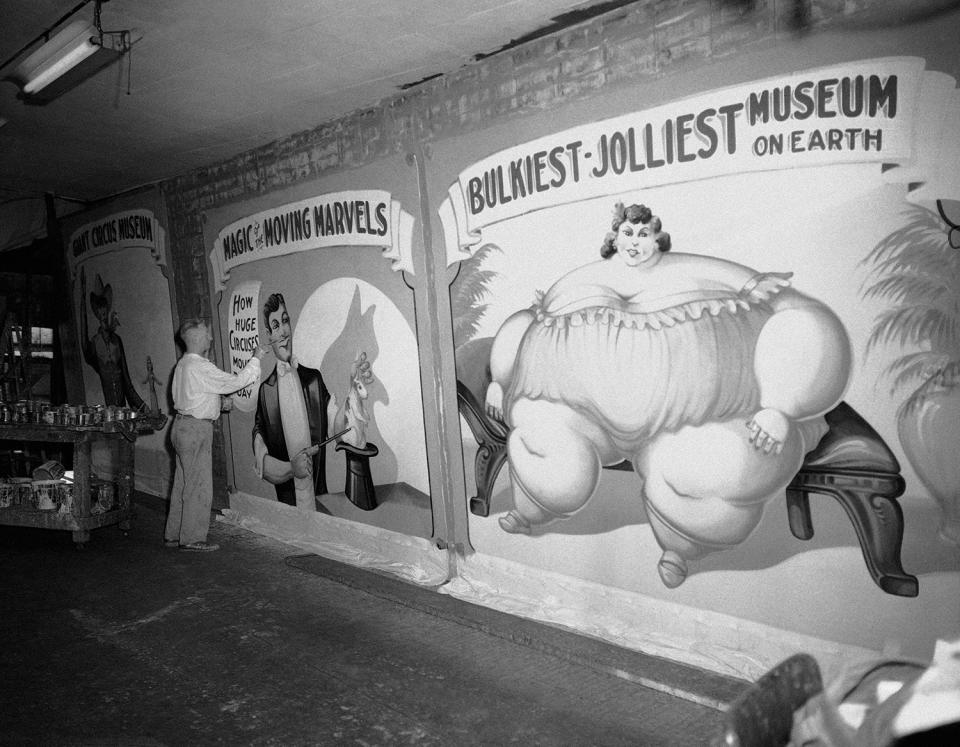 <p>Fred Johnson, 67, a banner artist of the old school, puts the final touches to huge banners on July 14, 1959 to be used in the new circus museum being installed at Baraboo, Wis. where the John Ringling Bros., circus began. Johnson still plys his art with a Chicago tent and awning firm. He began painting circus banners in 1909. (AP Photo/Edward Kitch) </p>