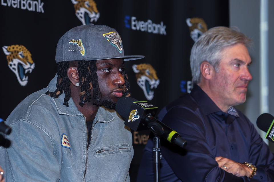 Jacksonville Jaguars first-round draft pick wide receiver Brian Thomas Jr., left, listens to a reporter's question while sitting beside head coach Doug Pederson during an NFL football press conference, Friday, April 26, 2024, in Jacksonville, Fla. (AP Photo/Gary McCullough)