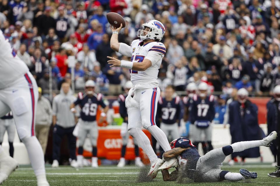 Bills quarterback Josh Allen gets off a pass under pressure against the Patriots.