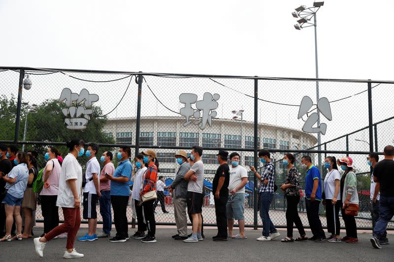 People line up to get a nucleic acid test at a sport center after a spike of cases of the coronavirus disease (COVID-19), in Beijing