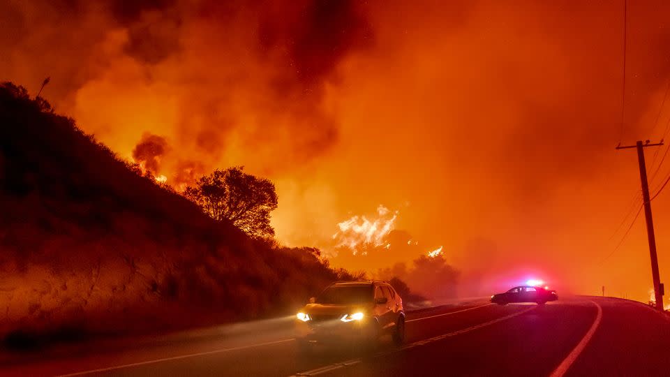 Cars escape the Bond Fire as it crosses near Silverado Canyon in Orange County, California, on December 3, 2020. It's always important when you're in fire-prone areas to know escape routes and back-up exits. - Leonard Ortiz/MediaNews Group/Orange County Register/Getty Images