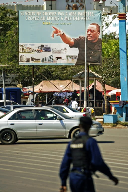 A policeman walks past a poster depicting Democratic Republic of Congo's President Joseph Kabila, in Lubumbashi on May 26, 2016