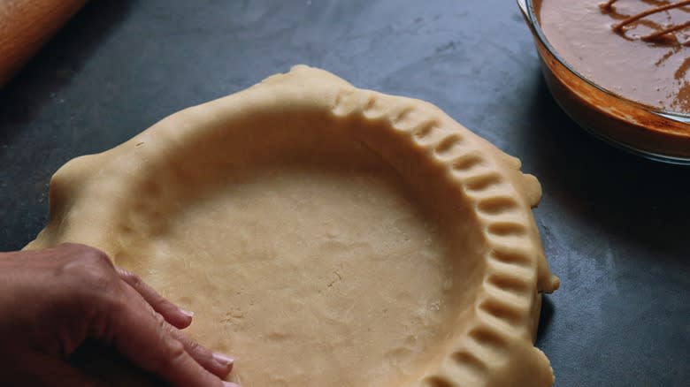 Preparing a pumpkin pie crust