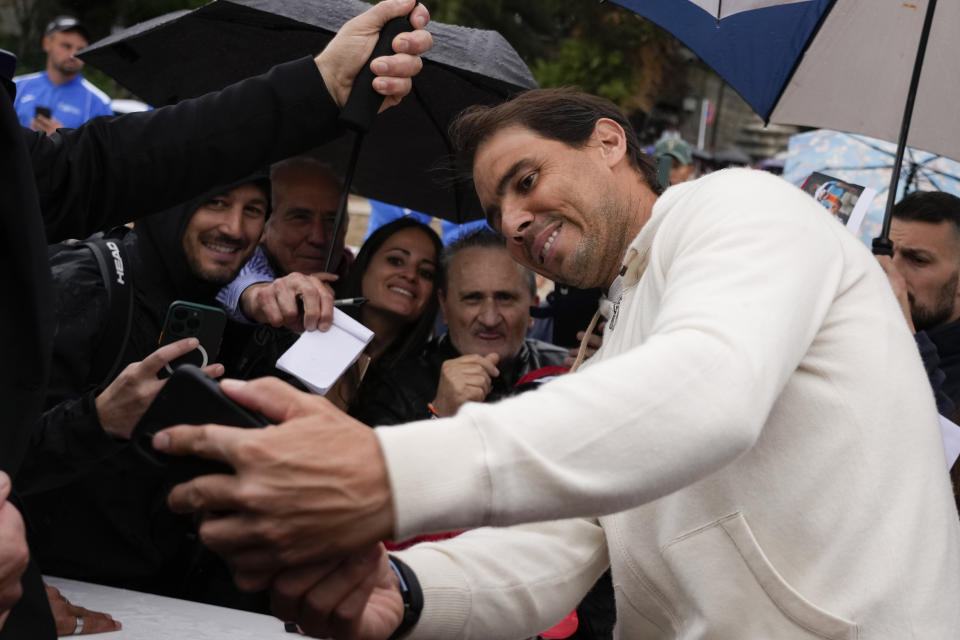 Rafael Nadal takes selfies with supporters during an event at Rome's Piazza Del Popolo, Wednesday, May 8, 2024. The 37-year-old Nadal, who has indicated that this will be his final year on tour, has played only nine matches this year after missing nearly all of 2023 due to a hip injury that required surgery. (AP Photo/Alessandra Tarantino)