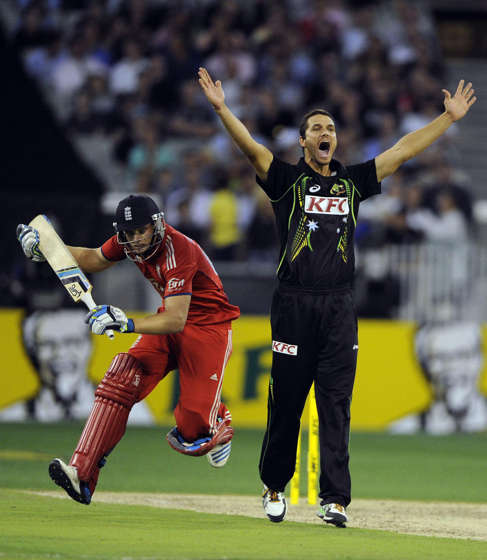 Australia's Nathan Coulter-Nile, right, celebrates the wicket of England's Jos Butler, left, during their T20 international cricket match at the Melbourne Cricket Ground in Melbourne, Australia, Friday, Jan. 31, 2014. (AP Photo/Andy Brownbill)