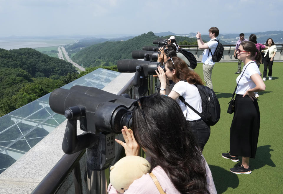 Visitors watch the North Korea side from the Unification Observation Post in Paju, South Korea, near the border with North Korea, Wednesday, July 19, 2023. North Korea was silent about the highly unusual entry of an American soldier across the Koreas' heavily fortified border although it test-fired short-range missiles Wednesday in its latest weapons display. (AP Photo/Ahn Young-joon)