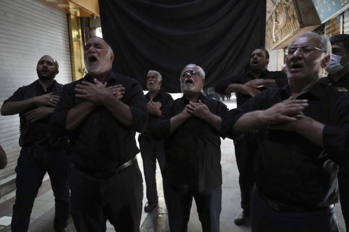 Mourners strike their chests during an annual procession commemorating Ashoura which marks the death anniversary of Imam Hussein, the grandson of Prophet Muhammad, who was killed with 72 of his companions in the 7th century in the Battle of Karbala in present-day Iraq, in Tehran, Iran, Monday, Aug. 8, 2022. (AP Photo/Vahid Salemi)