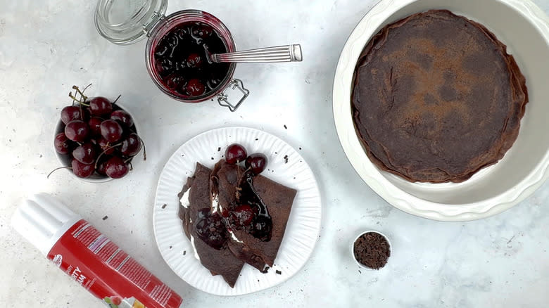 chocolate crepes with cream and cherry sauce