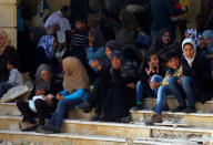 People, who were evacuated from the two rebel-besieged Shi'ite villages of al-Foua and Kefraya, wait at insurgent-held al-Rashideen, to travel to government-controlled Aleppo, Syria April 19, 2017. REUTERS/Ammar Abdullah