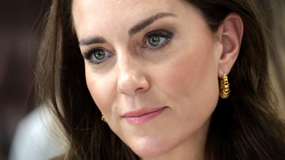 Close-up of Kate Middleton looking serious and wearing gold earrings