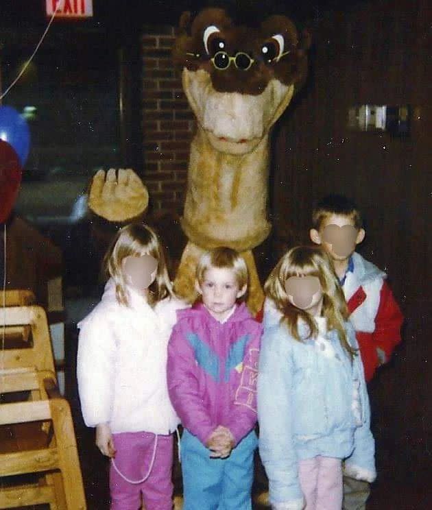 Children posing with Littlefoot from the Land Before Time at Pizza Hut