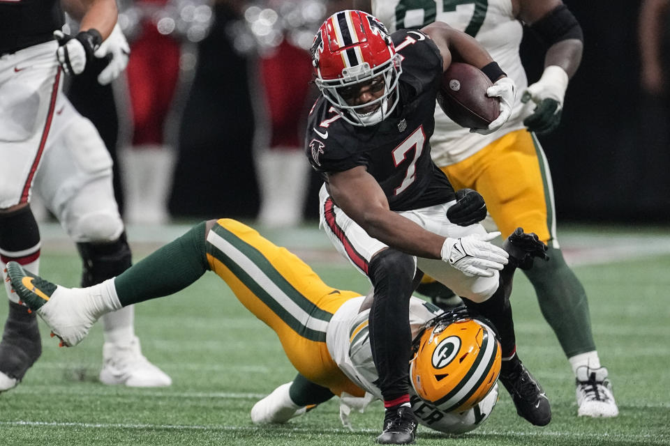 Atlanta Falcons running back Bijan Robinson (7) runs over Green Bay Packers linebacker Quay Walker (7) during the first half of an NFL football game, Sunday, Sept. 17, 2023, in Atlanta. (AP Photo/John Bazemore)