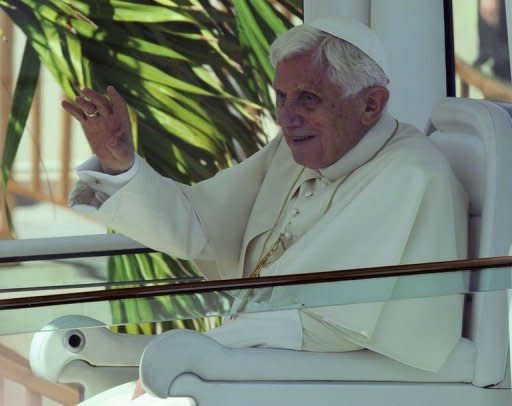 Pope Benedict XVI waves from inside the popemobile upon arrival at Antonio Macedo airport, in Santiago de Cuba