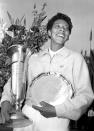 FILE - In this Sept. 9, 1957, file photo, Althea Gibson smiles as she holds her trophies she won by capturing the National women's singles tennis championship at the West Side Tennis Club in Forest Hills, N.Y. Gibson won an amazing 11 Grand Slam titles in three years from 1956-58, including the French Open, Wimbledon and U.S. Open. On Monday, Aug. 26, 2019, the USTA will unveil a statue in her honor at the U.S. Open. (AP Photo, File)