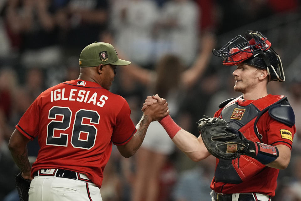 Atlanta Braves relief pitcher Raisel Iglesias (26) celebrates with catcher Sean Murphy after the team's win over the Seattle Mariners in a baseball game Friday, May 19, 2023, in Atlanta. (AP Photo/Brynn Anderson)