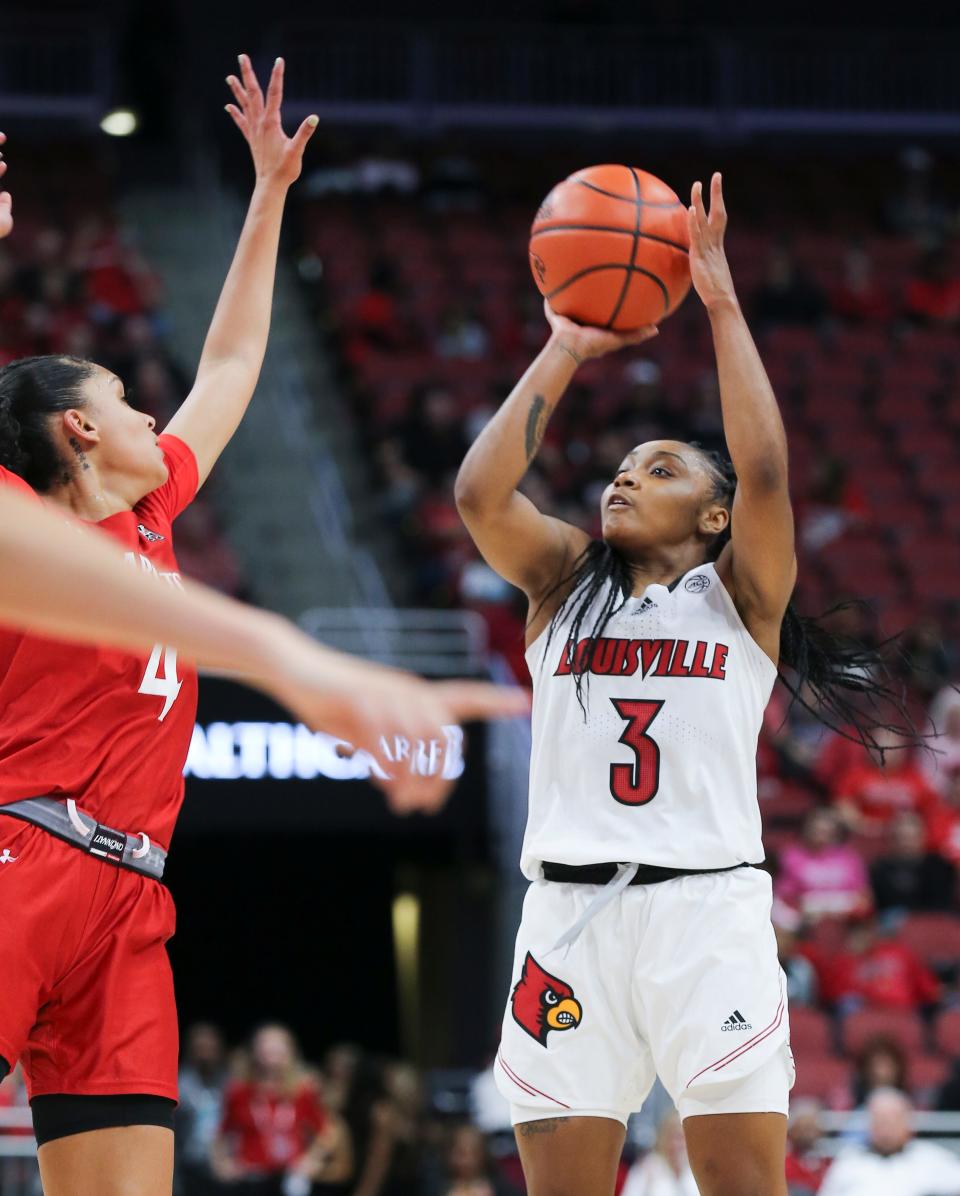 U of L's Chrislyn Carr (3) shoots against Cincinnati defenders during their game at the Yum Center in Louisville, Ky. on Nov. 7, 2022. Carr is a graduate transfer who previously played at Texas Tech and Syracuse.