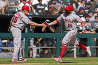 Los Angeles Angels' Jose Rojas, right, celebrates with third base coach Brian Butterfield after hitting a two-run home run during the fourth inning of a baseball game against the Chicago White Sox in Chicago, Thursday, Sept. 16, 2021. (AP Photo/Nam Y. Huh)