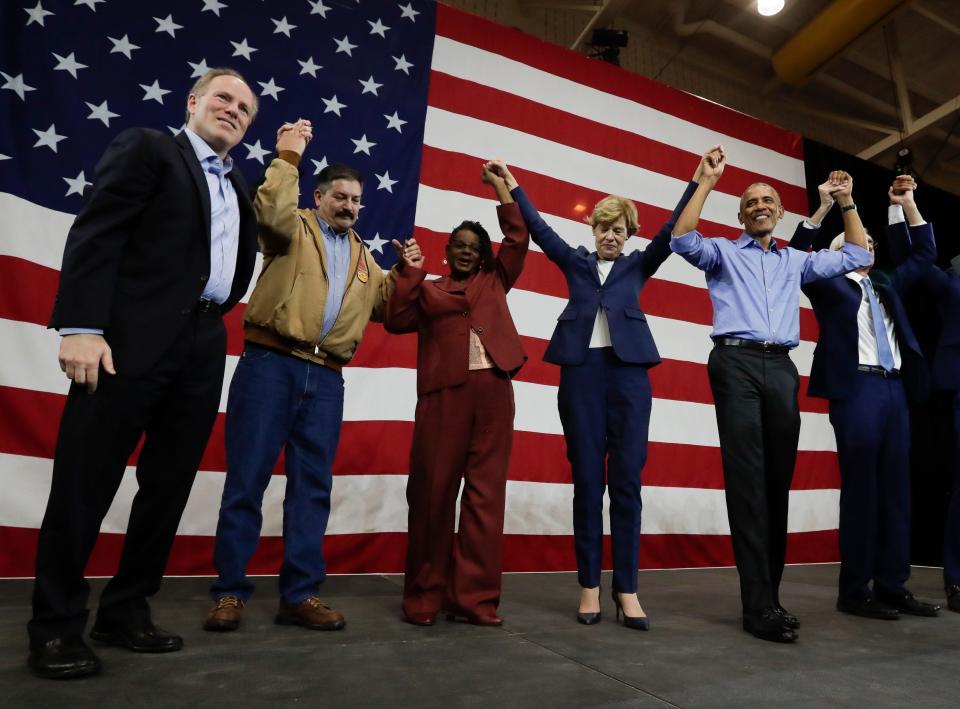 In this Oct. 26, 2018 file photo, former President Barack Obama poses with Democrats after speaking at a rally in support of Wisconsin Democratic candidates, in Milwaukee.  Democrats are putting great focus on the state that Obama won twice but that President Donald Trump won in 2016.