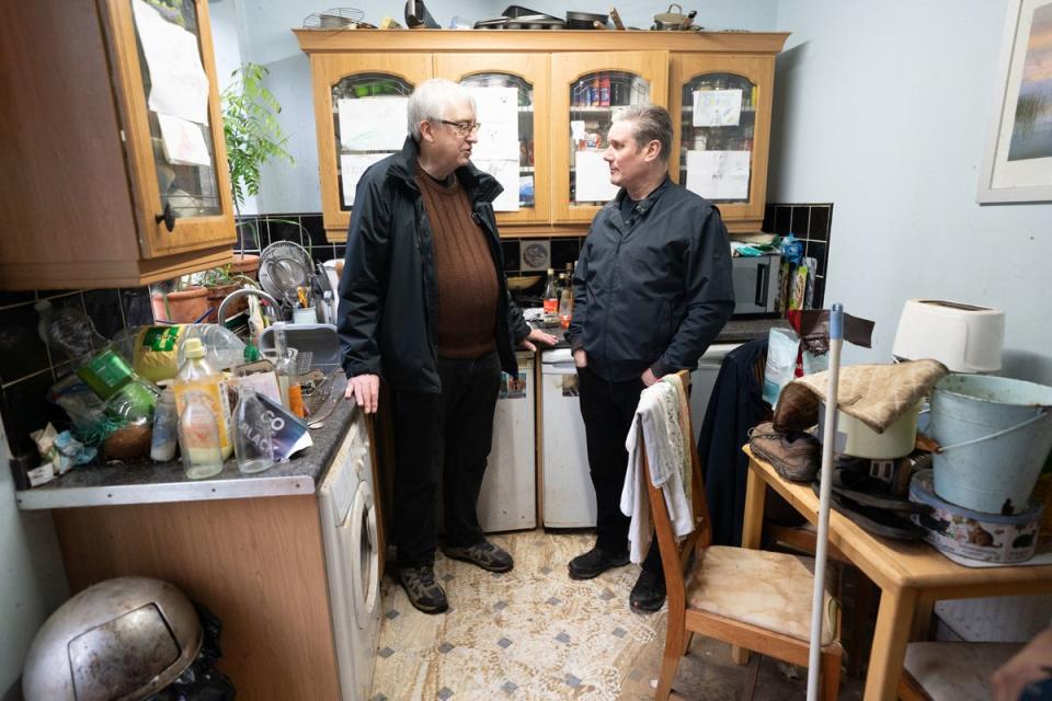 Keir Starmer meets Ian Clement whose house in Loughborough, East Midlands flooded (PA)