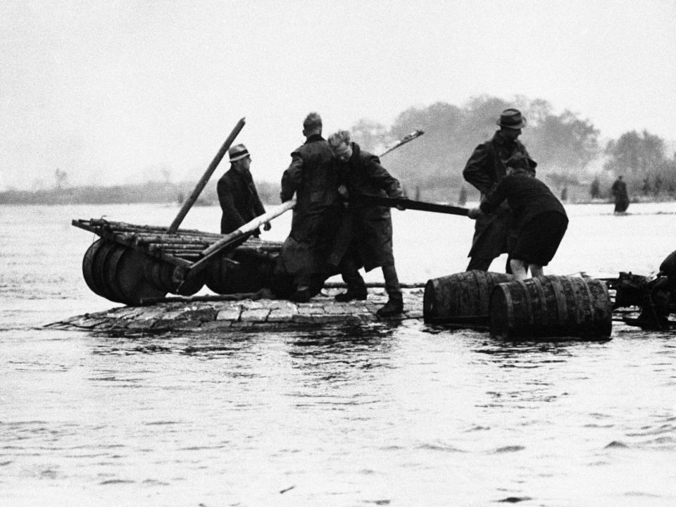 FILE - In this May 7, 1945 file photo German soldiers are marooned as they try to make a raft to get across to the Allied lines to surrender, in Germany. Nazi commanders signed their surrender to Allied forces in a French schoolhouse 75 years ago this week, ending World War II in Europe and the Holocaust. (AP Photo, File)