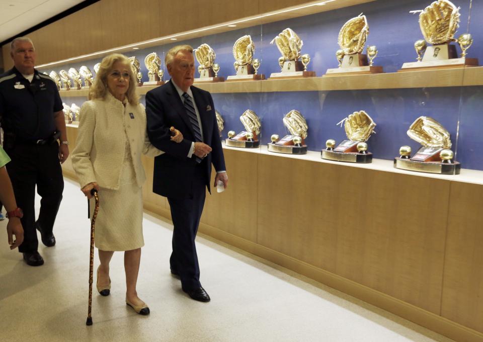 <p>Los Angeles Dodgers Hall of Fame broadcaster Vin Scully, right, and his wife Sandra Hunt Scully walk past a display of Dodger award as they head for a ceremony where Vin Scully was to be honored before a baseball game against the Colorado Rockies at Dodger Stadium, Friday, Sept. 23, 2016. (AP Photo/Reed Saxon) </p>