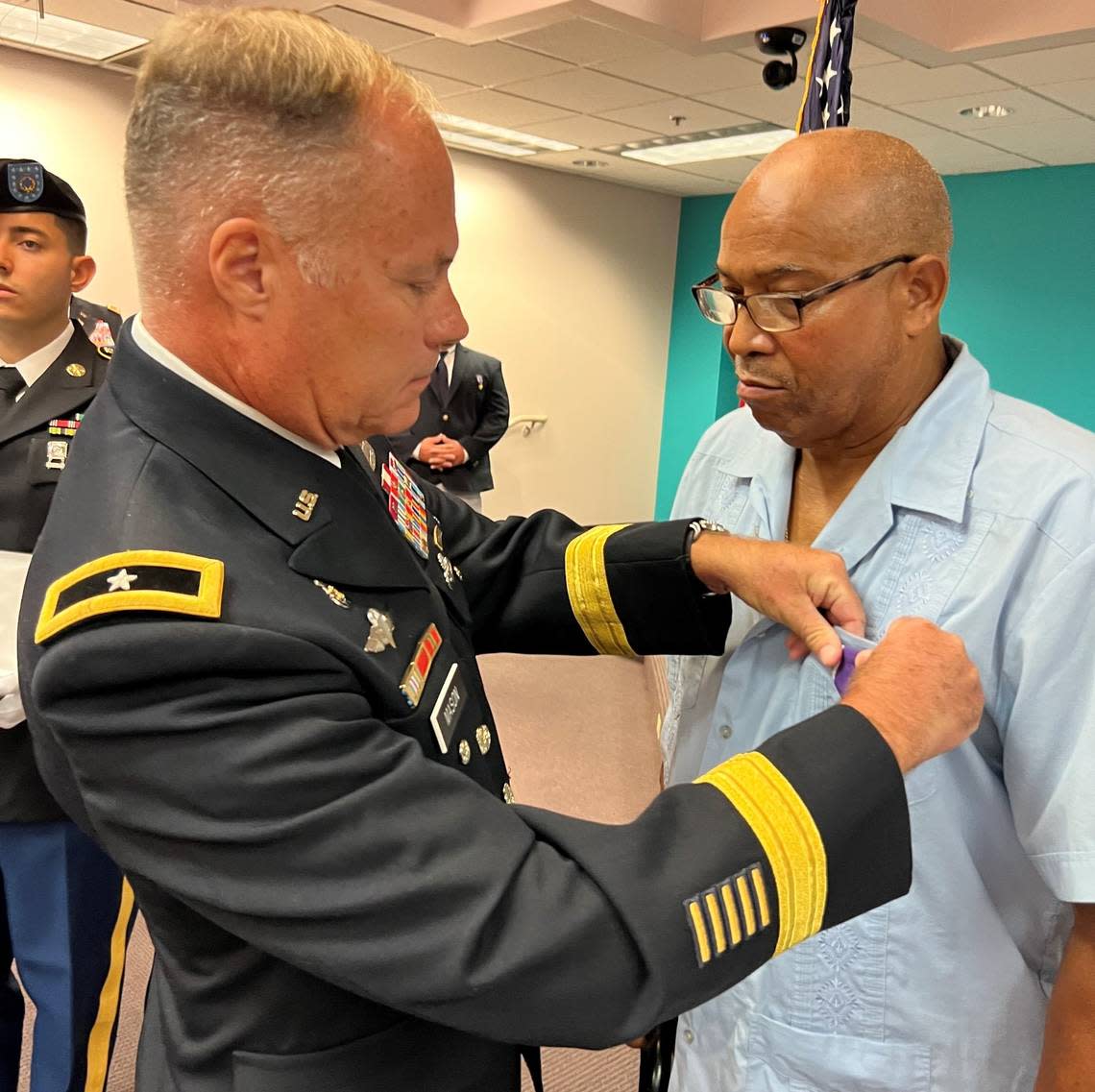 Retired Army General William B. Mason III pins a Purple Heart on the chest of Vietnam veteran Alvin Alce, of Key West, on Aug. 8, 2022.