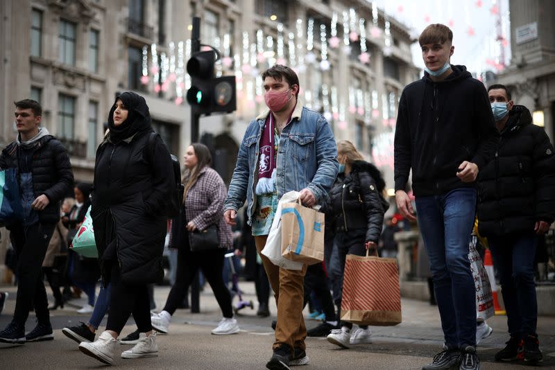 FILE PHOTO: Shoppers walk through Oxford Circus, amid the coronavirus disease (COVID-19) outbreak in London