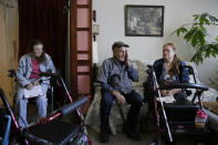 From left, Sharon Wagner-Higgins, Brian Cherry and Theresa Metzger talk about their experiences of being stranded in the dark during the power blackouts at the Villas at Hamilton housing complex for low income seniors Wednesday, Oct. 30, 2019, in Novato, Calif. Pacific Gas & Electric officials said they understood the hardships caused by the blackouts but insisted they were necessary. (AP Photo/Eric Risberg)