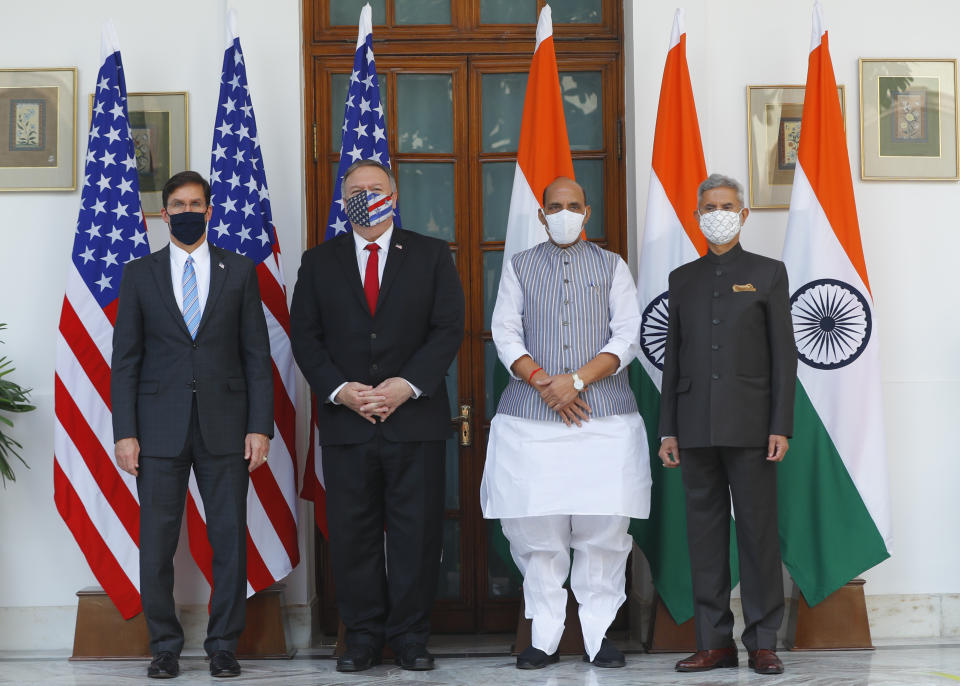 U.S. Secretary of State Mike Pompeo, second left, and Secretary of Defence Mark Esper, left, stand for photographs with Indian Foreign Minister Subrahmanyam Jaishankar, right, and Defence Minister Rajnath Singh ahead of their meeting at Hyderabad House in New Delhi, India, Tuesday, Oct. 27, 2020. In talks on Tuesday with their Indian counterparts, Pompeo and Esper are to sign an agreement expanding military satellite information sharing and highlight strategic cooperation between Washington and New Delhi with an eye toward countering China. (Adnan Abidi/Pool via AP)