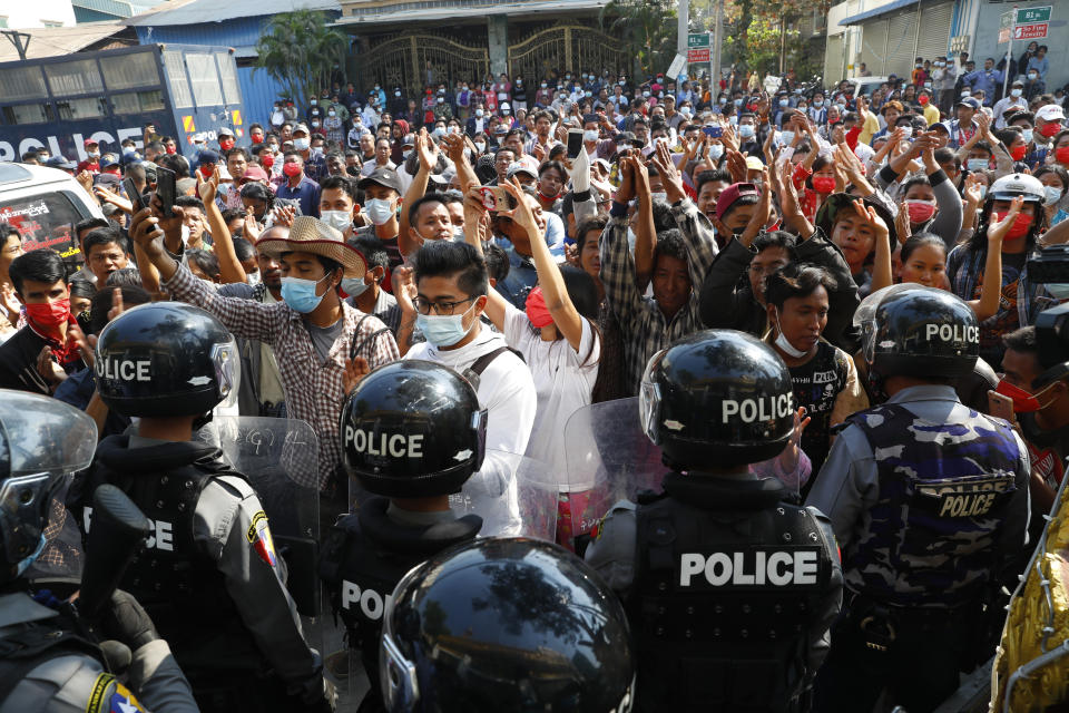 Residents and protesters face riot police as they question them about recent arrests made in Mandalay, Myanmar, Saturday, Feb. 13, 2021. Daily rallies against the coup occurring in Myanmar's two largest cities, Yangon and Mandalay, enter its second week despite a ban on public gatherings of five or more. (AP Photo)