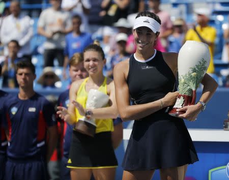 Aug 20, 2017; Mason, OH, USA; Garbine Muguruza raises the Rookwood Cup championship trophy after the womens finals match against Simona Halep during the Western & Southern Open at the Lindner Family Tennis Center. Mandatory Credit: Sam Greene/The Cincinnati Enquirer via USA TODAY NETWORK