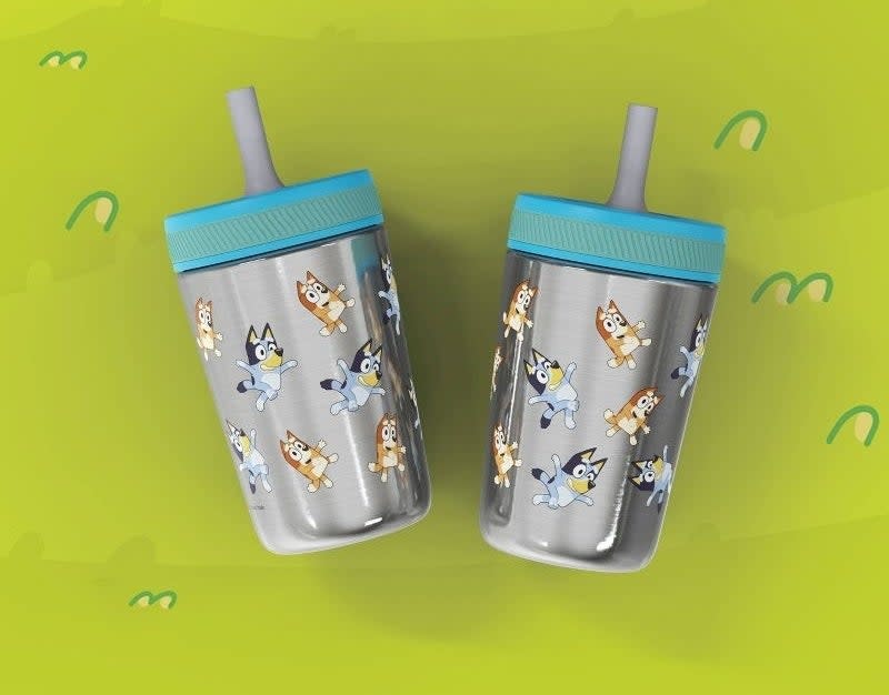 Two children's sippy cups with cartoon dog print and silicone straws, ideal for kids' drinkware