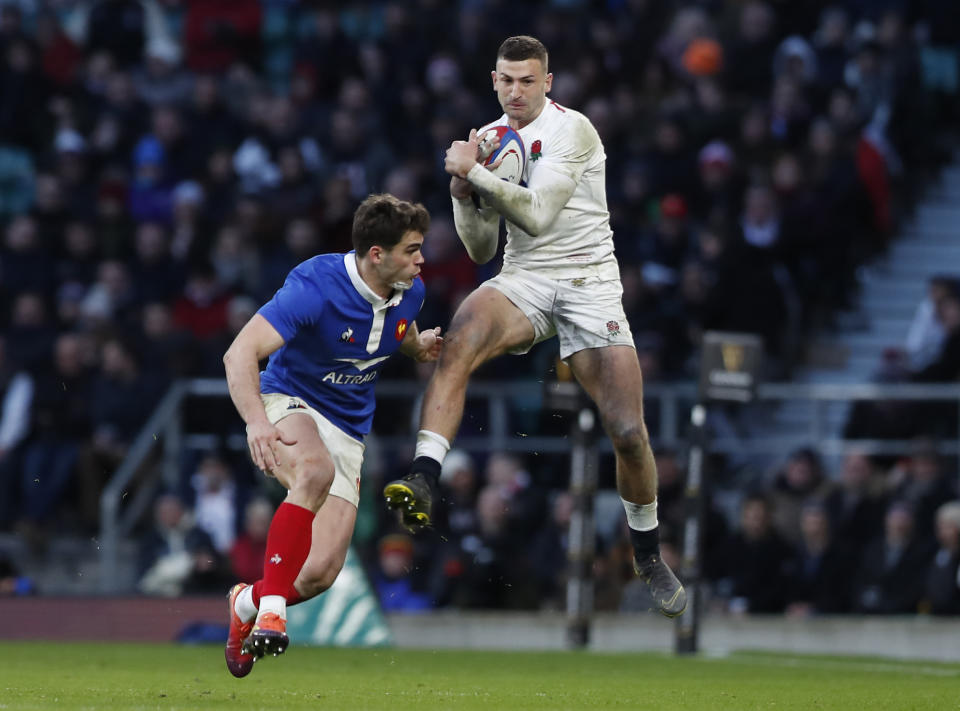 England's Jonny May catches the ball and is challenged by Damian Penaud of France during the Six Nations rugby union international between England and France at Twickenham stadium in London, Sunday, Feb. 10, 2019. (AP Photo/Alastair Grant)