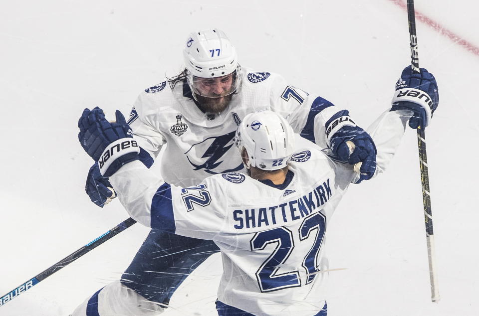 Tampa Bay Lightning defenseman Kevin Shattenkirk (22) celebrates his goal against the Dallas Stars with Victor Hedman (77) during overtime in Game 4 of the NHL hockey Stanley Cup Final, Friday, Sept. 25, 2020, in Edmonton, Alberta. (Jason Franson/The Canadian Press via AP)