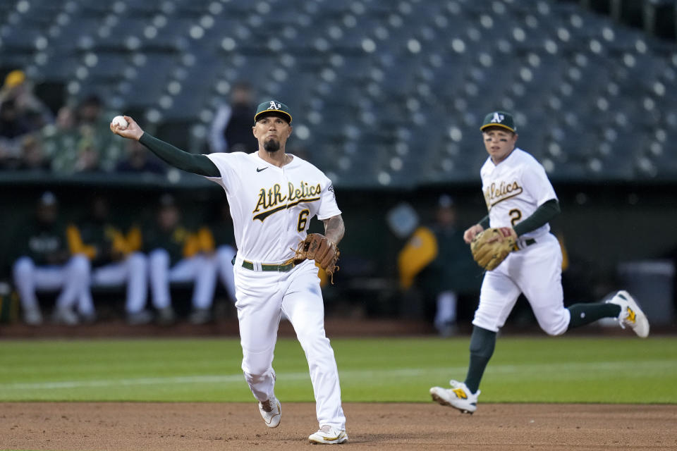 Oakland Athletics third baseman Jace Peterson, left, throws to first for an out on Seattle Mariners' Eugenio Suárez during the first inning of a baseball game in Oakland, Calif., Wednesday, May 3, 2023. (AP Photo/Godofredo A. Vásquez)