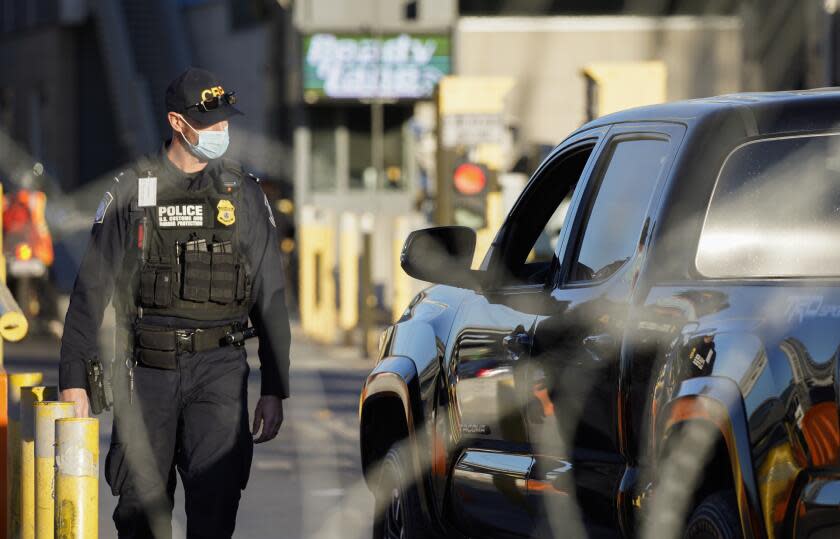 Tijuana, Baja California - February 04: A U.S. Customs and Border Protection agent inspects a truck. Morning traffic at the San Ysidro Port of Entry on Friday, Feb. 4, 2022 in Tijuana, Baja California. (Alejandro Tamayo / The San Diego Union-Tribune)