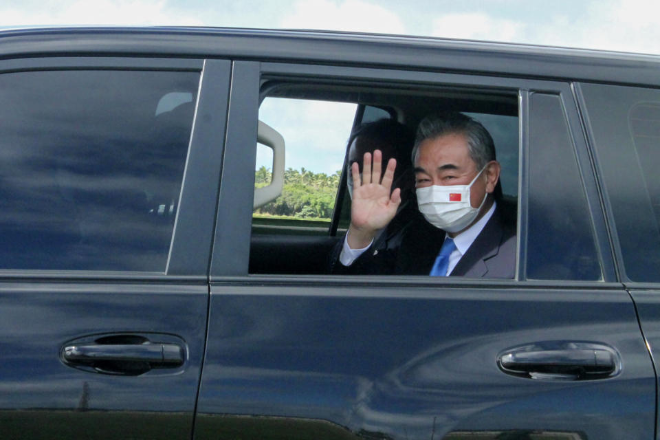 China's Foreign Minister Wang Yi waves from his car after he was welcomed by officials on his arrival in Nuku'alofa, Tonga, Tuesday, May 31, 2022. Wang and a 20-strong delegation are in Tonga as part of an eight-nation Pacific Islands tour that comes amid growing concerns about Beijing's military and financial ambitions in the South Pacific region. (Marian Kupu/ABC via AP)