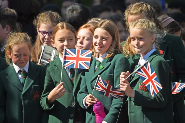 School children wait to get a glimpse of The Duchess of Cambridge as she leaves Bletchley Park 