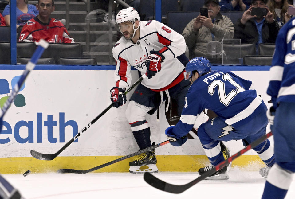 Washington Capitals left wing Alex Ovechkin handles the puck during the first period of an NHL hockey game against the Tampa Bay Lightning, Sunday, Nov. 13, 2022, in Tampa, Fla. (AP Photo/Jason Behnken)