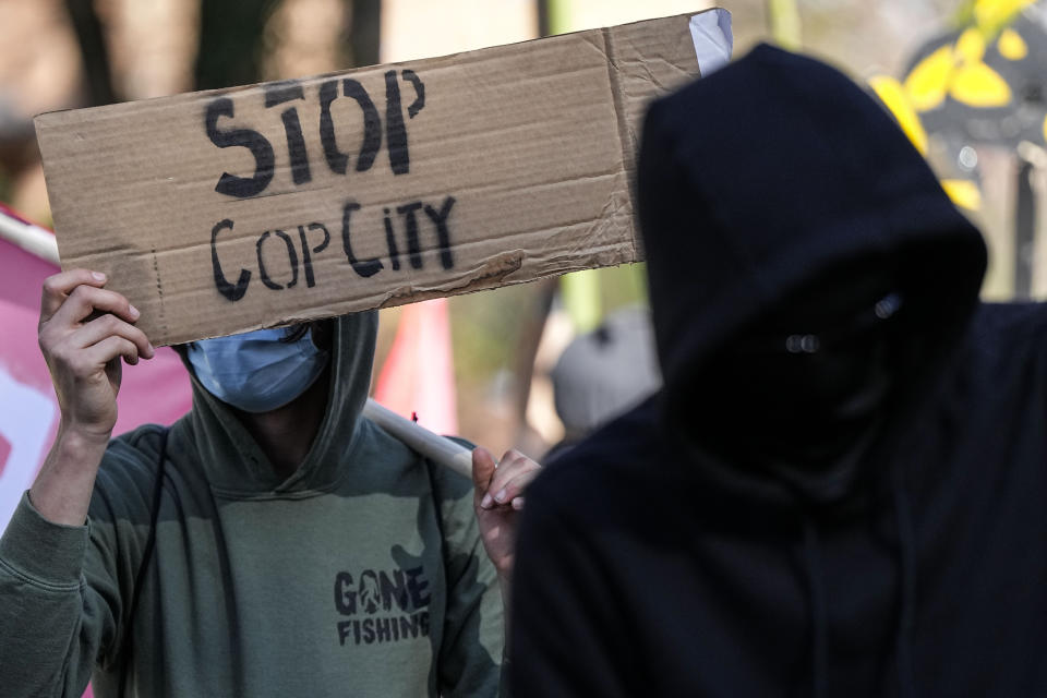 Protesters march during a demonstration in opposition to a new police training center, Monday, Nov. 13, 2023, in Atlanta. (AP Photo/Mike Stewart)