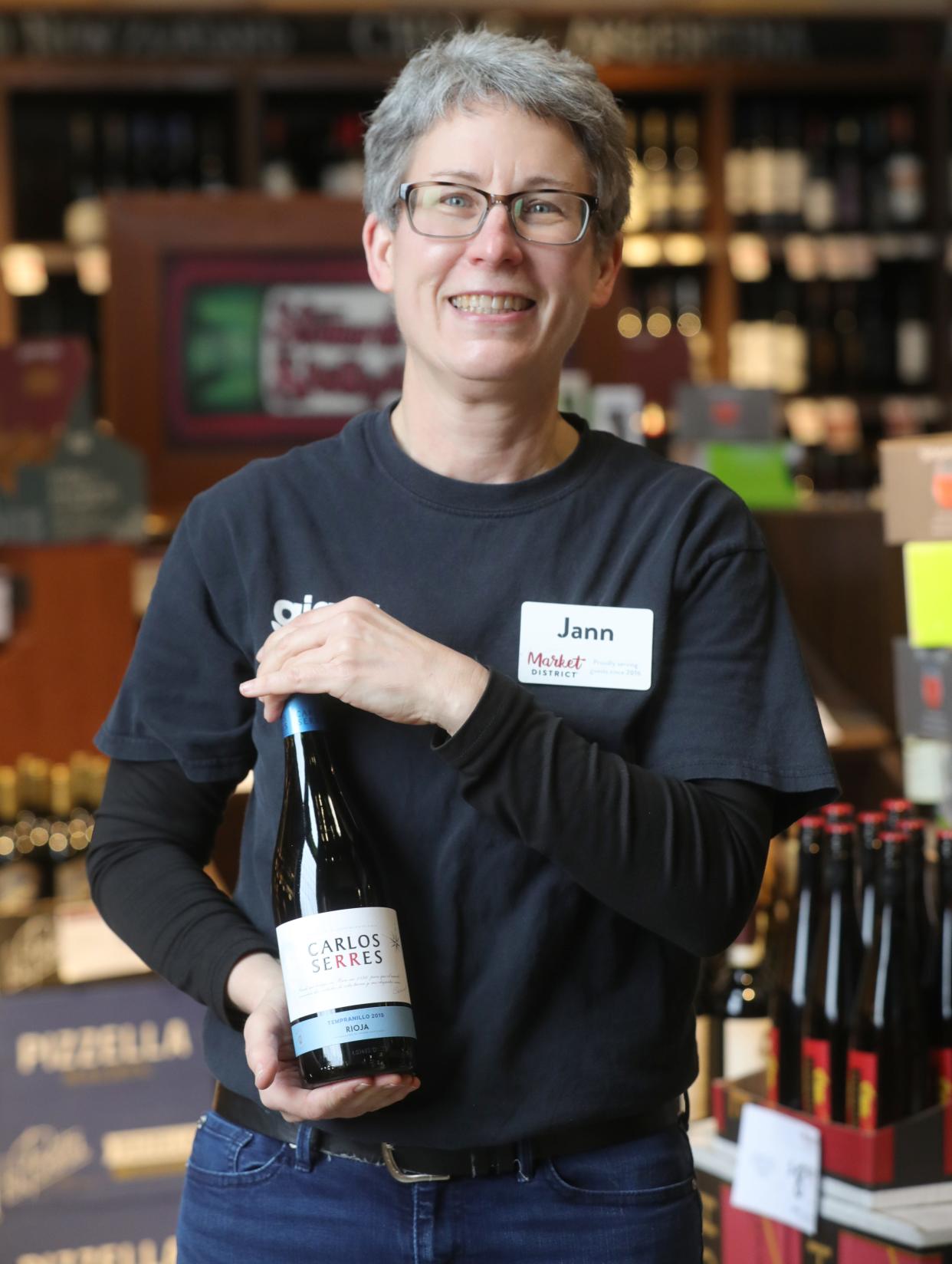 Jann Filion, wine steward at Market District in Cuyahoga Falls, with her favorite under $10 wine, Carlos Serres Tempranillo.