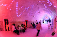 Tourists have dinner inside the Balea Lac Hotel of Ice in the Fagaras mountains, 300km (184 miles) northwest of Bucharest December 28, 2011. Entirely made of ice, the hotel offers accommodation in 10 double rooms with king size beds, where the temperature is between -2 and +2 degrees Celsius, at a price of 35 Euro ($45.73) per person. REUTERS/Radu Sigheti