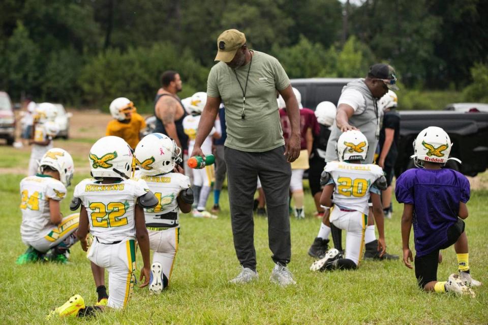 The Greenview Eagles coaches give water to players during a practice at the former W.G. Sanders Middle School in Columbia, South Carolina on Thursday, July 7, 2022.