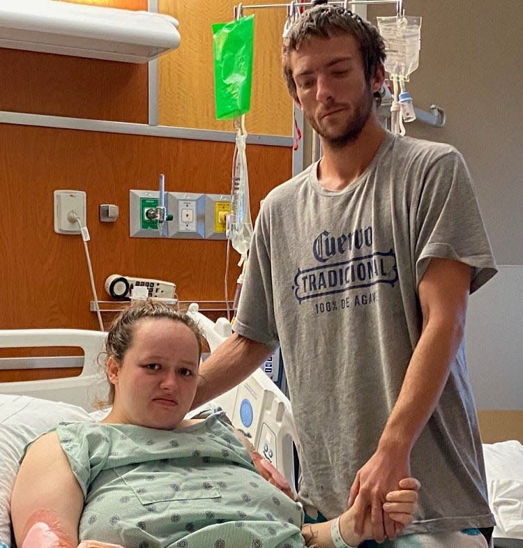 Muncie resident Kasie Hullinger - shown with her fiance, Travis Vannatter - on Friday was spending her sixth day recovering at IU Health Ball Memorial Hospital after being attacked and severely injured by two pit bulls.