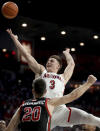 Arizona guard Pelle Larsson (3) shoots despite getting fouled by Utah guard Lazar Stefanovic (20) in the first half of an NCAA college basketball game in Tucson, Ariz., Saturday, Jan. 15, 2022. (Kelly Presnell/Arizona Daily Star via AP)