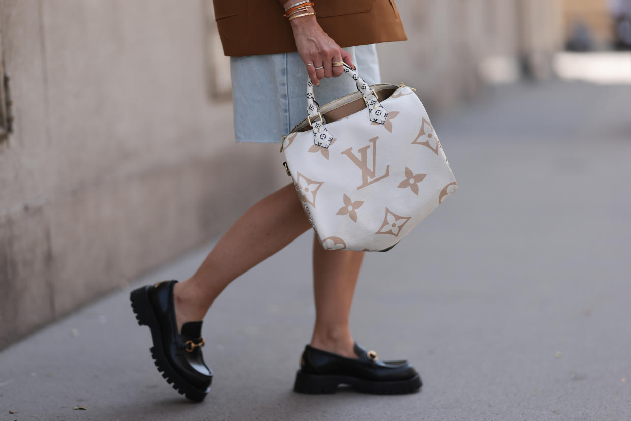 Model Karin Teigl wearing Gucci black leather loafer, Louis Vuitton beige brown speedy bag, and Prada brown blazer jacket on May 1, 2023 in Vienna, Austria. (Photo by Jeremy Moeller/Getty Images)