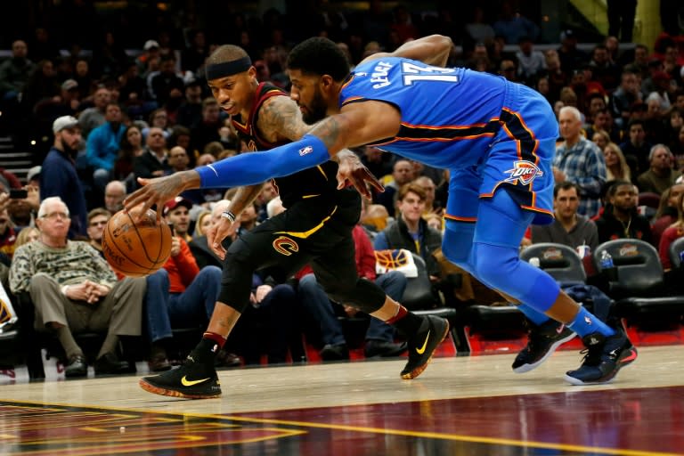 Isaiah Thomas of the Cleveland Cavaliers and Paul George of the Oklahoma City Thunder scramble after a loose ball