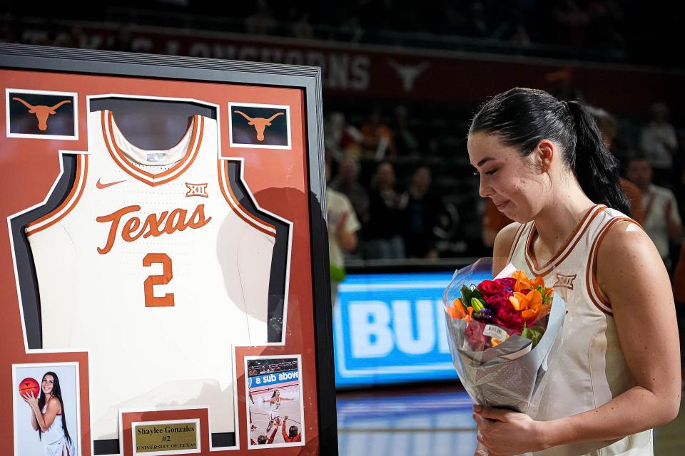 Texas guard Shaylee Gonzales looks at a framed jersey that was presented to her on Senior Night after the Longhorns' 71-46 win over BYU at Moody Center on March 2. Gonzales, who had exhausted her college eligibility, declared for the WNBA draft on Tuesday.