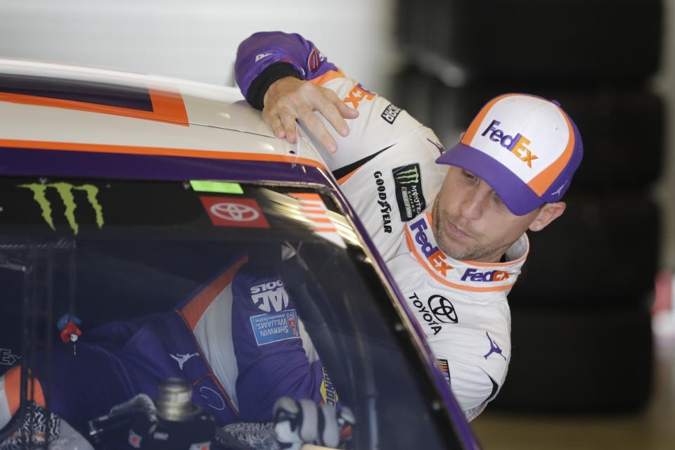 Monster Energy NASCAR Cup Series driver Denny Hamlin climbs into his car during practice for the NASCAR Brickyard 400 auto race at the Indianapolis Motor Speedway, Saturday, Sept. 7, 2019 in Indianapolis. (AP Photo/Darron Cummings)