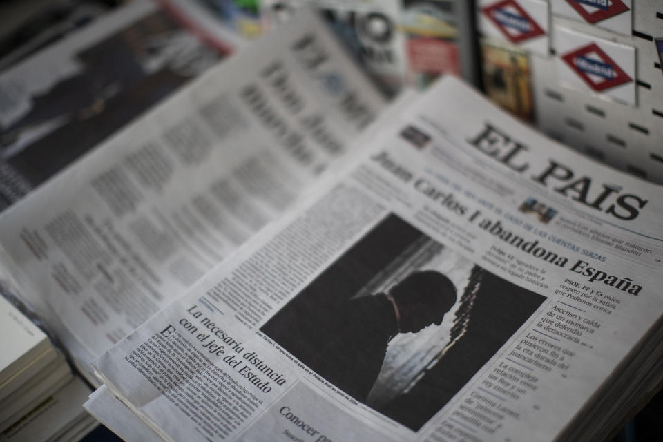 Front pages of newspapers are displayed with the news of Spain's former monarch, King Juan Carlos I, in Madrid, Spain, Tuesday, Aug. 4, 2020. Speculation over the whereabouts of former monarch Juan Carlos is gripping Spain, a day after he announced he was leaving the country for an unspecified destination amid a growing financial scandal. (AP Photo/Manu Fernandez)